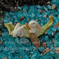 Miniature Rabbits Rowing a Leaf Boat