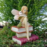 Miniature Fairy Reading on a Stack of Books