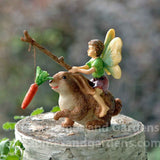 Little Boy Fairy Motivating a Rabbit with Stick and Carrot